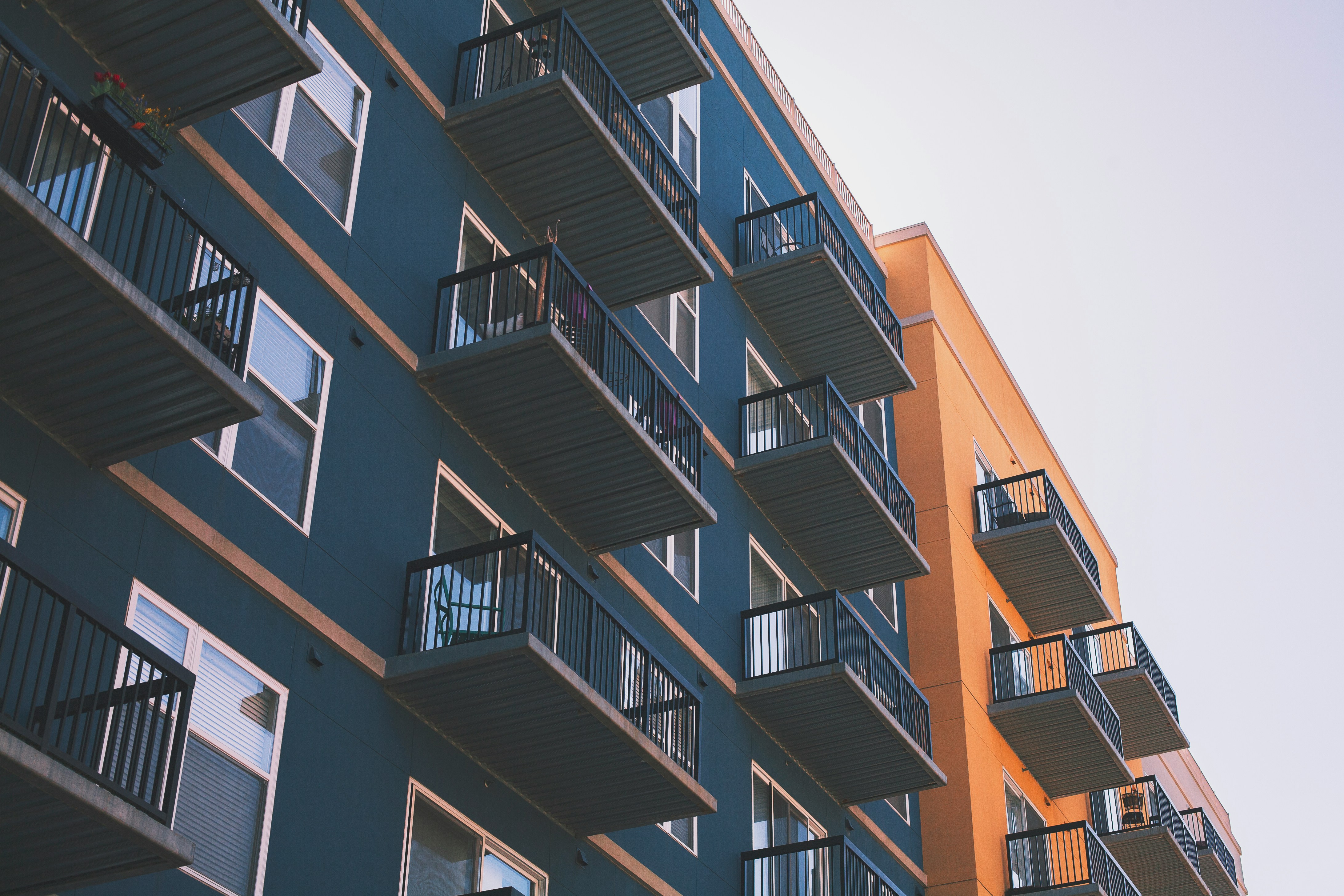 Blue and orange multifamily apartment building with balconies