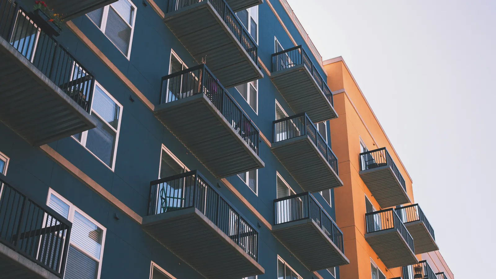 Blue and orange multifamily apartment building with balconies