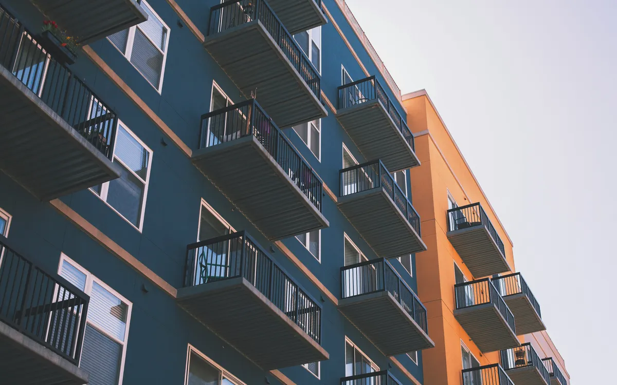 Blue and orange multifamily apartment building with balconies